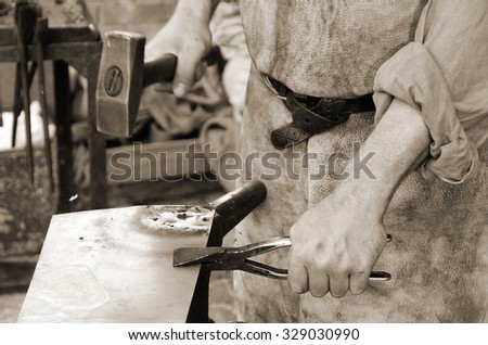 blacksmith at work in the repair shop in italy
