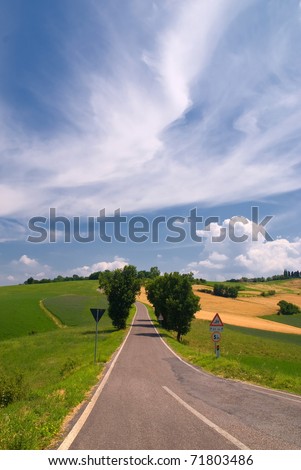 street in countryside under soft clouds