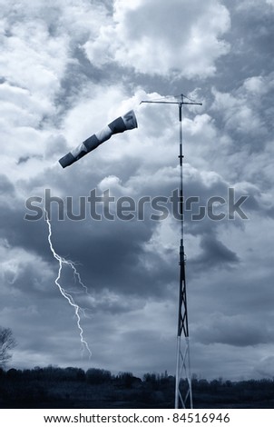 wind direction indicator under cloudy sky with lightning