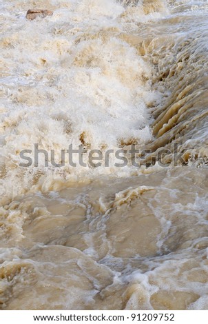 dangerous rapids with brown water