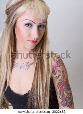 stock photo Blonde biker chick covered in tattoos and a smug expression