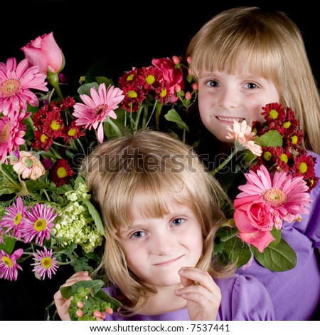 Twin girls surrounded by a bouquet of flowers