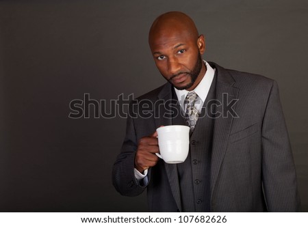 Young black business man holding a coffee mug