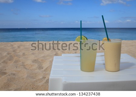Two frozen drinks on a table at the beach