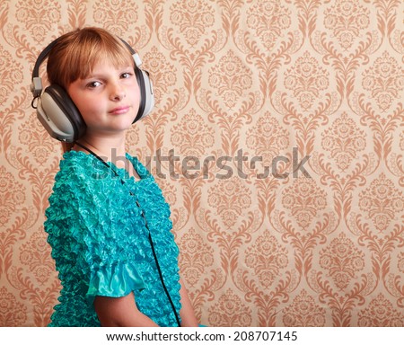 Gradeschool girl at home listening to music on a pair of vintage 1970s wired headphones