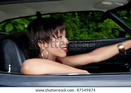 Hispanic woman in an old car