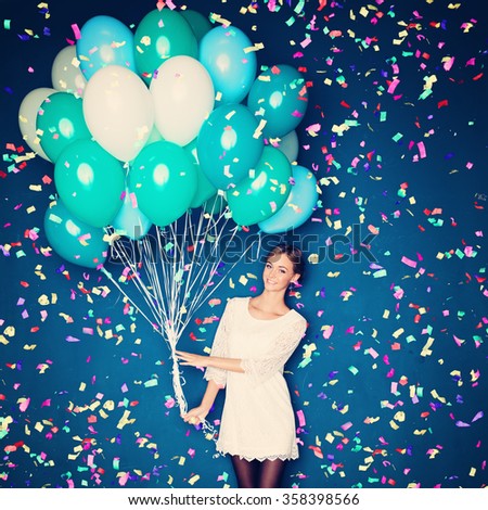 Cheerful Woman with  Balloons and Confetti on Blue Background