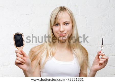 Smiling woman holding comb and scissors - beauty industry
