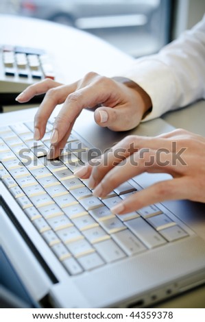 Office lady typing on laptop computer