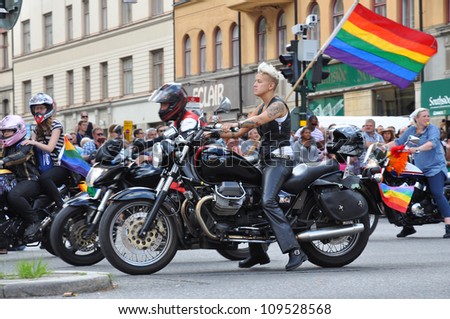 STOCKHOLM, SWEDEN - AUGUST 4: An unidentified woman on bike participates in the pride parade on August 4, 2012, Stockholm. Approximately 50,000 people march the parade and 500,000 bystanders watch the parade.