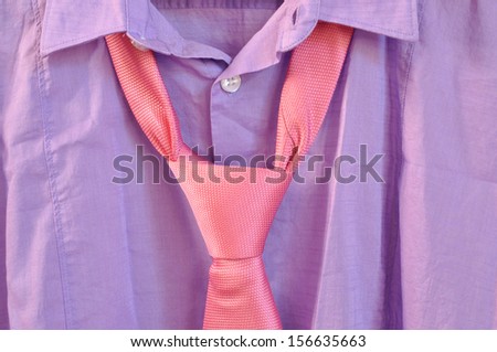 Closeup of purple shirt with pink necktie