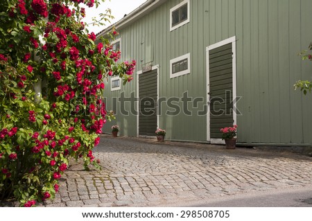 Roses and flower pots in alley.