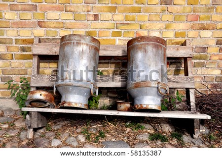Two old, rusty milk cans.