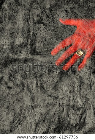 Red hand touching rough gray background.