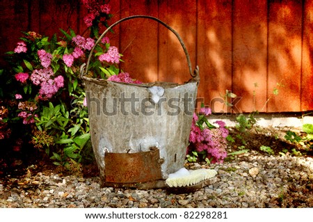 Vintage wash bucket with brush in grunge.