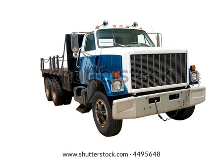 This is a mid 1980's heavy duty flatbed truck viewed from the front corner. isolated on white.