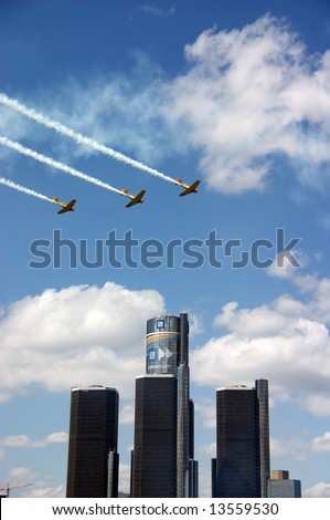 Three planes flying over the Renaissance Center in Detroit, MI during the Red Bull Air Races.