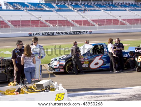 LAS VEGAS, NV - SEPTEMBER 26: Colin Braun chats with girlfriend Melissa Fields and team mate while the pit crew readies the #6 Ford for qualifying during the Sept. 26, 2009 Las Vegas 350.