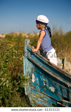 Toddler boy-young captain in an old boat.