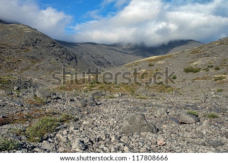 Khibiny Mountains, Upper reaches of Mannepahk Stream and mountain range between Indivichvumchorr and Putelichorr Mounts with Northern Chorrgor Pass in clouds, Kola Peninsula, Russia
