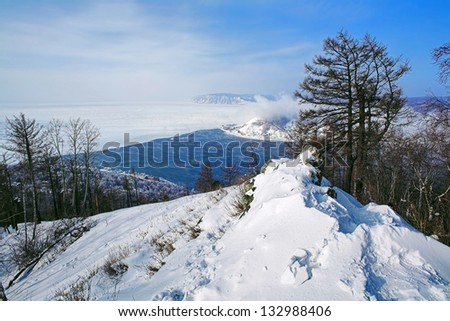 Winter view of Baikal Lake and the source of Angara River from the mountain Stone of Czerski above the Listvyanka settlement, Siberia, Russia