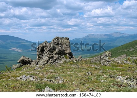 Northern Ural Mountains, Rock on the Third Bugor Mount and view on mountains Kosvinsky Rock and Konzhakovsky Rock, Russia