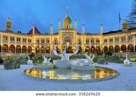 COPENHAGEN, DENMARK - DECEMBER 14, 2015: The Christmas installation with Swans in front of the Moorish Palace in Tivoli Gardens. Since 2008 in the palace located the five-star boutique hotel Nimb.