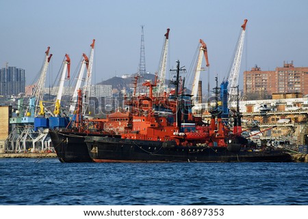 Red-black ships and harbour cranes in Vladivostok, Far East, Russia