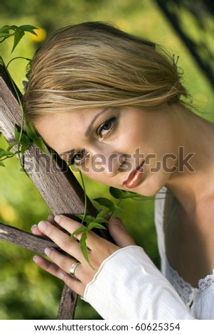 Young bride with her wedding ring, day dreaming.