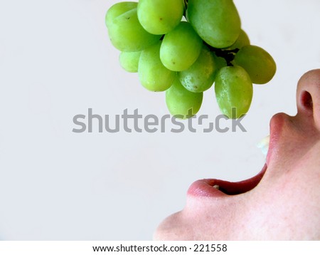 Man eating grapes.