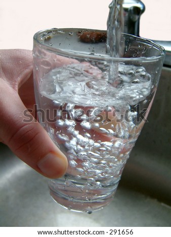 Filling glass with water.