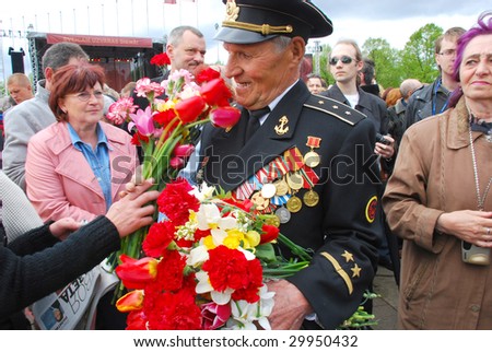 RIGA, LATVIA - MAY, 9 : A veteran celebrates day of a victory in the Second World War at a monument to liberators of Riga on May 9, 2009 in Riga, Latvia.