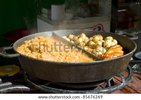 Rural meal. The big frying pan with hot meal