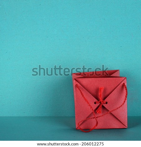 Gift bag in red, is isolated on a background in turquoise