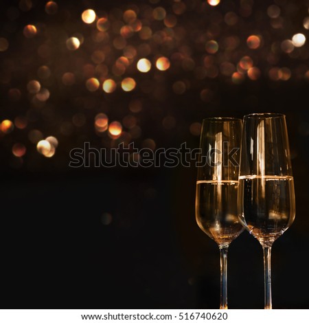 Champagne for festive occasions against a dark background with gold shimmering light and bokeh