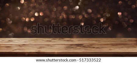 Gold shimmering panorama for public holidays in front of a wooden table and a concept