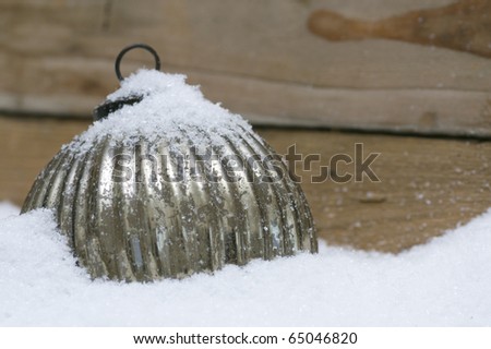 Silver sphere for christmas tree in the snow