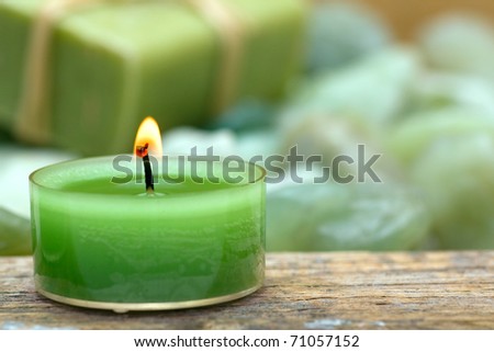 Wellness candle with soap and green stones close-up