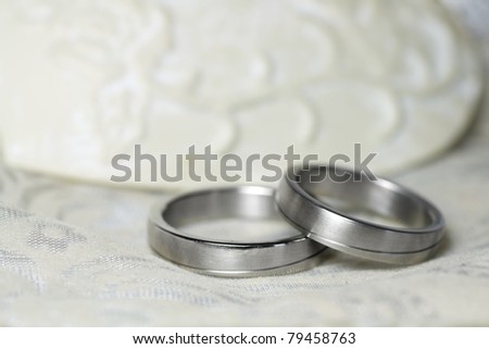 stock photo Wedding rings in silver on a beautiful tablecloth
