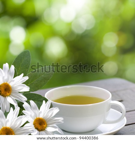 Chamomile tea with white flowers served on the terrace