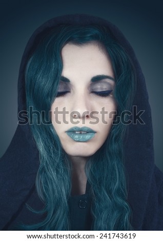Fantasy portrait of a woman with closed eyes in cold colors