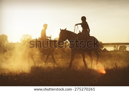 Picture of horseman riding a horse in the evening.