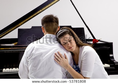 Couple with Grand piano 4 sitting at piano bench with red rose.