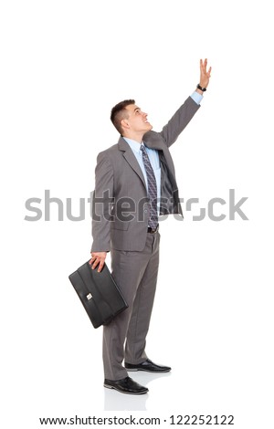 concept of businessman get something with hand take upwards, grab form above, raised up arm point palm finger, business man hold brief case press virtual button, full length isolated white background