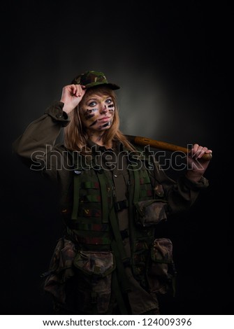 army girl hold shovel, soldier woman in a military uniform over black background