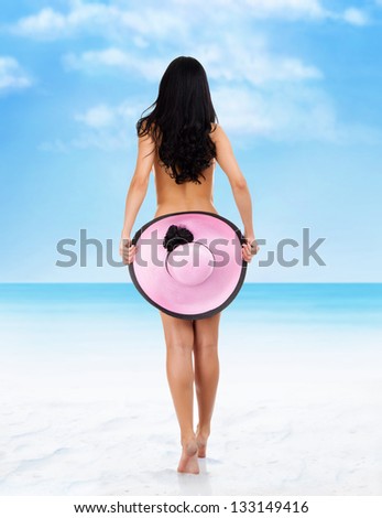 Rear view back of young beautiful woman brunette wearing summer beach hat and bikini cover ass back, concept of travel holiday over sea tropical ocean blue sky vacation