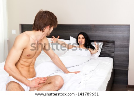 young couple in bedroom, man lover sitting, excited happy smile woman lying in a bed embrace, love romantic valentine day concept