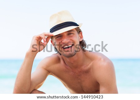 man smile on beach summer vacation, Handsome young male wear hat, sun tanned body, guy over sea blue sky, concept ocean holiday travel
