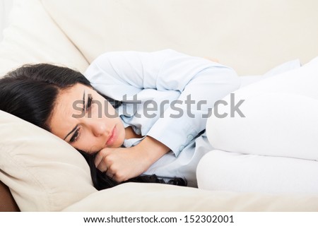 Sick Woman, Ill, Stomach Ache Female Hold Hand On Stomach, Young Unhealthy Girl Pain Lying At Home On Sofa Couch