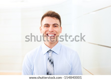 smiling handsome businessman at office conference hall, business man happy smile wear blue shirt tie